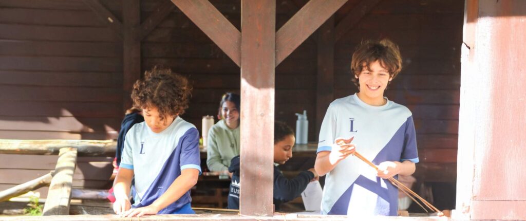 Students taking part in an outdoor bow-making activity