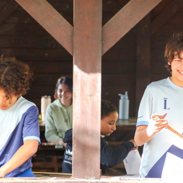 Students taking part in an outdoor bow-making activity