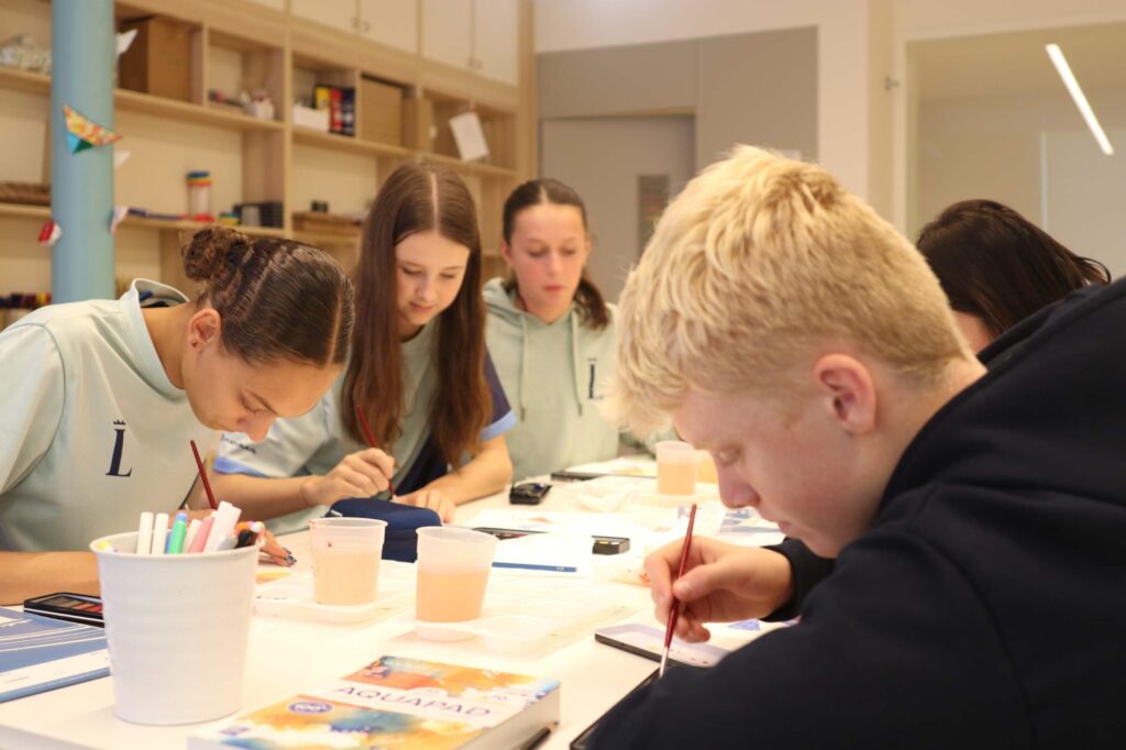 Secondary students collaborating in class