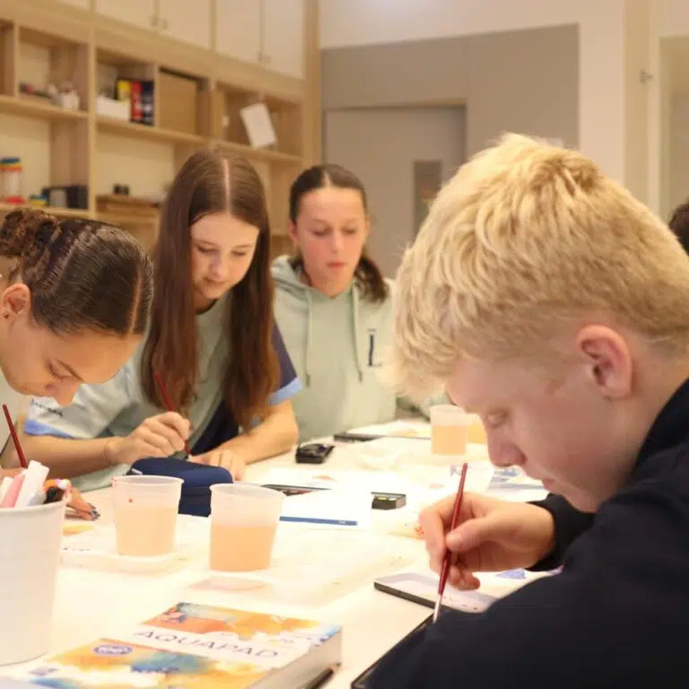 Secondary students collaborating in class