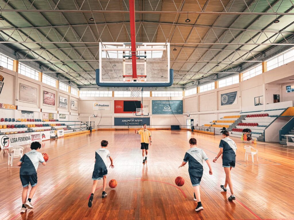 Students playing basketball in the sports hall