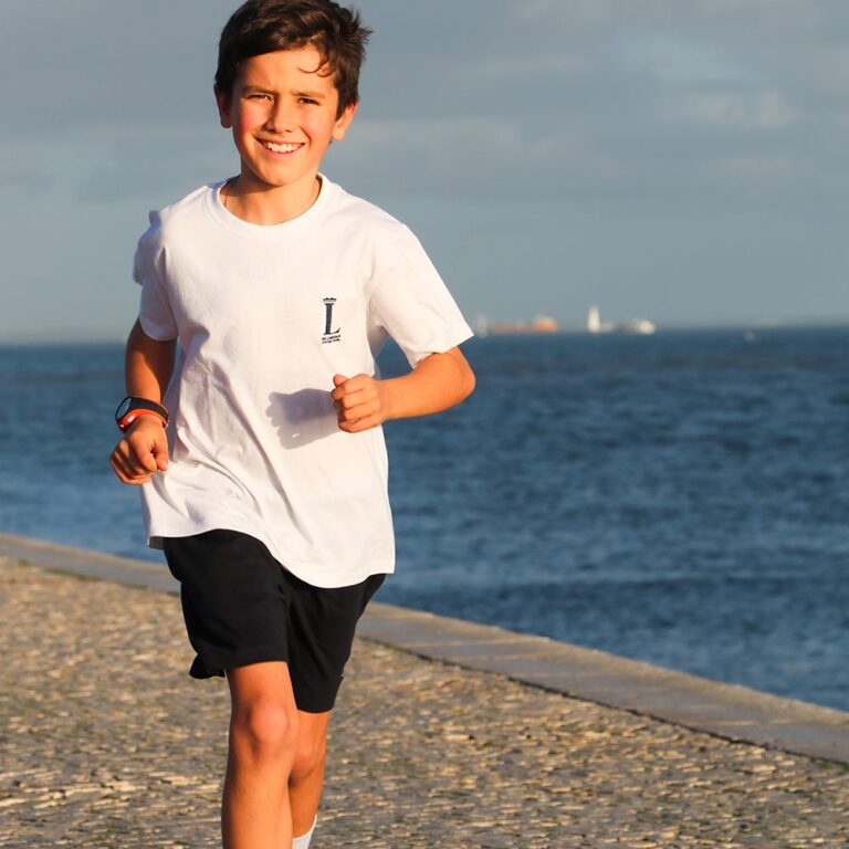 Student running on the beach