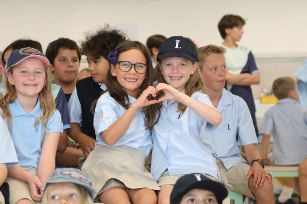 Smiling students at a Lisboan assembly
