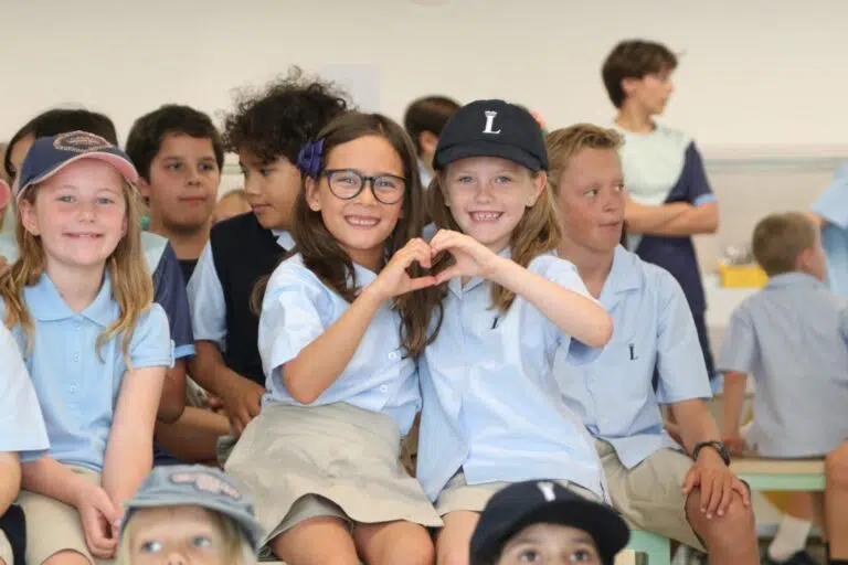 Smiling students at a Lisboan assembly