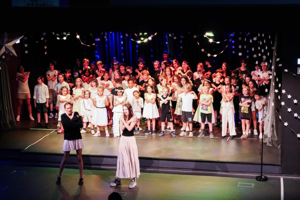 Students performing on stage at The Lisboan