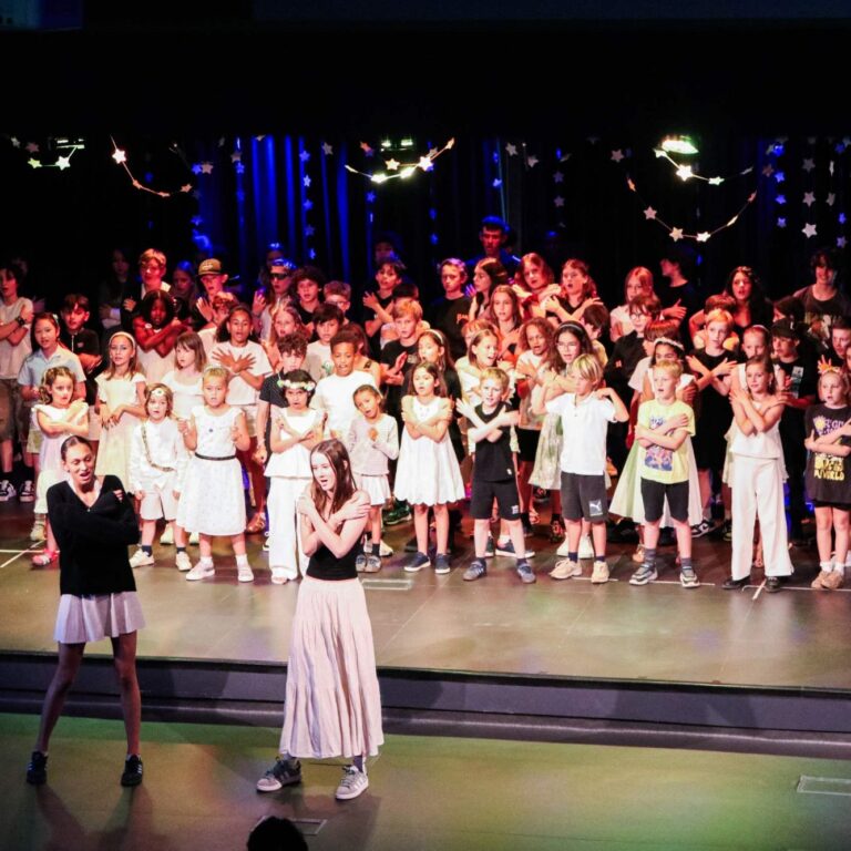 Students performing on stage at The Lisboan